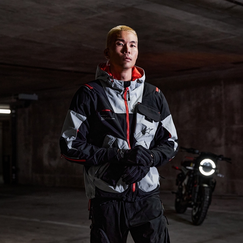 Alpinestars MOGRESS AIR melna-mandeļkrāsas-oranža motocikla jaka
